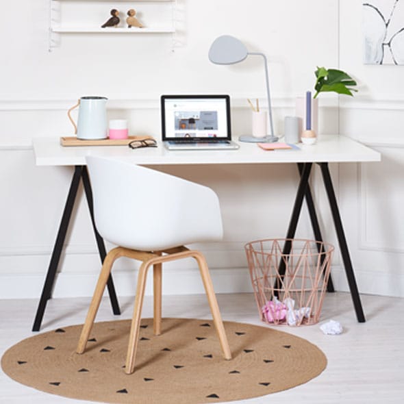 Photo of a workplace with white desk, white chair and open laptop